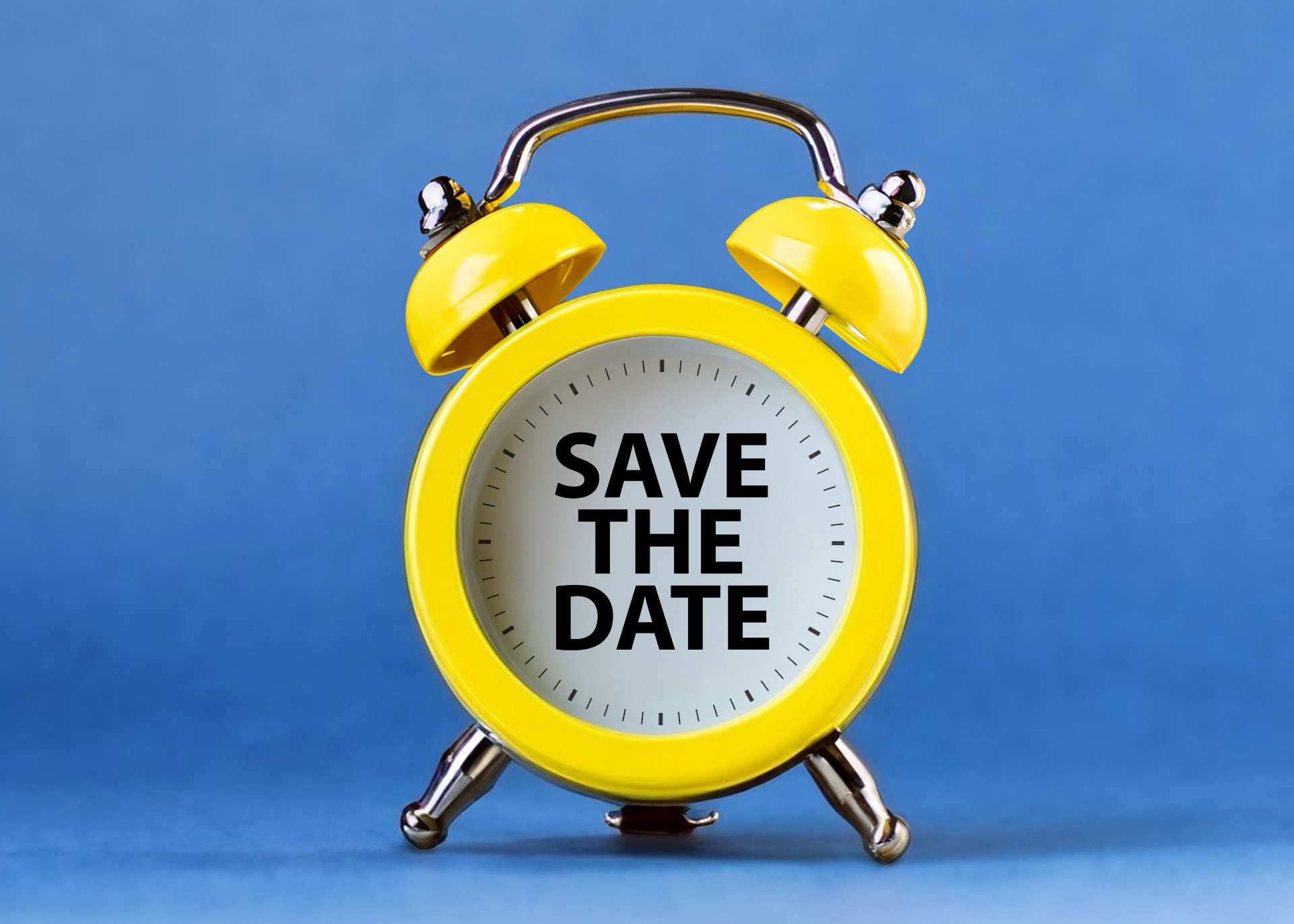Gelber Wecker mit Schriftzug "Save the Date"